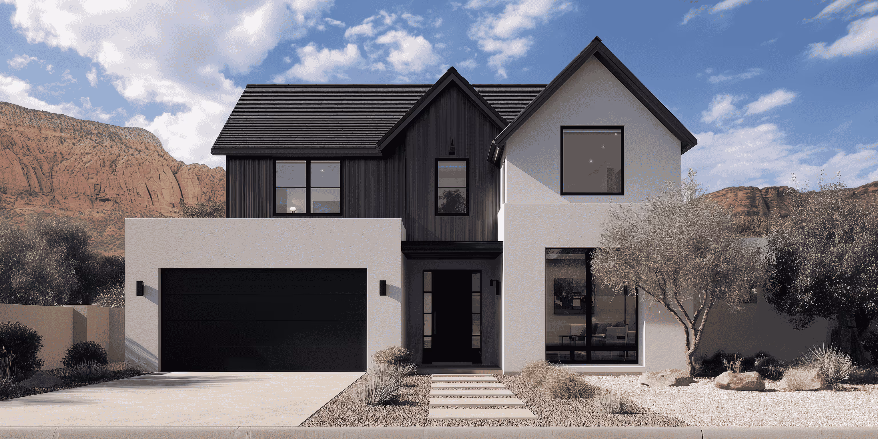 Modern two-story house with black and white exterior, large windows, and desert landscaping.