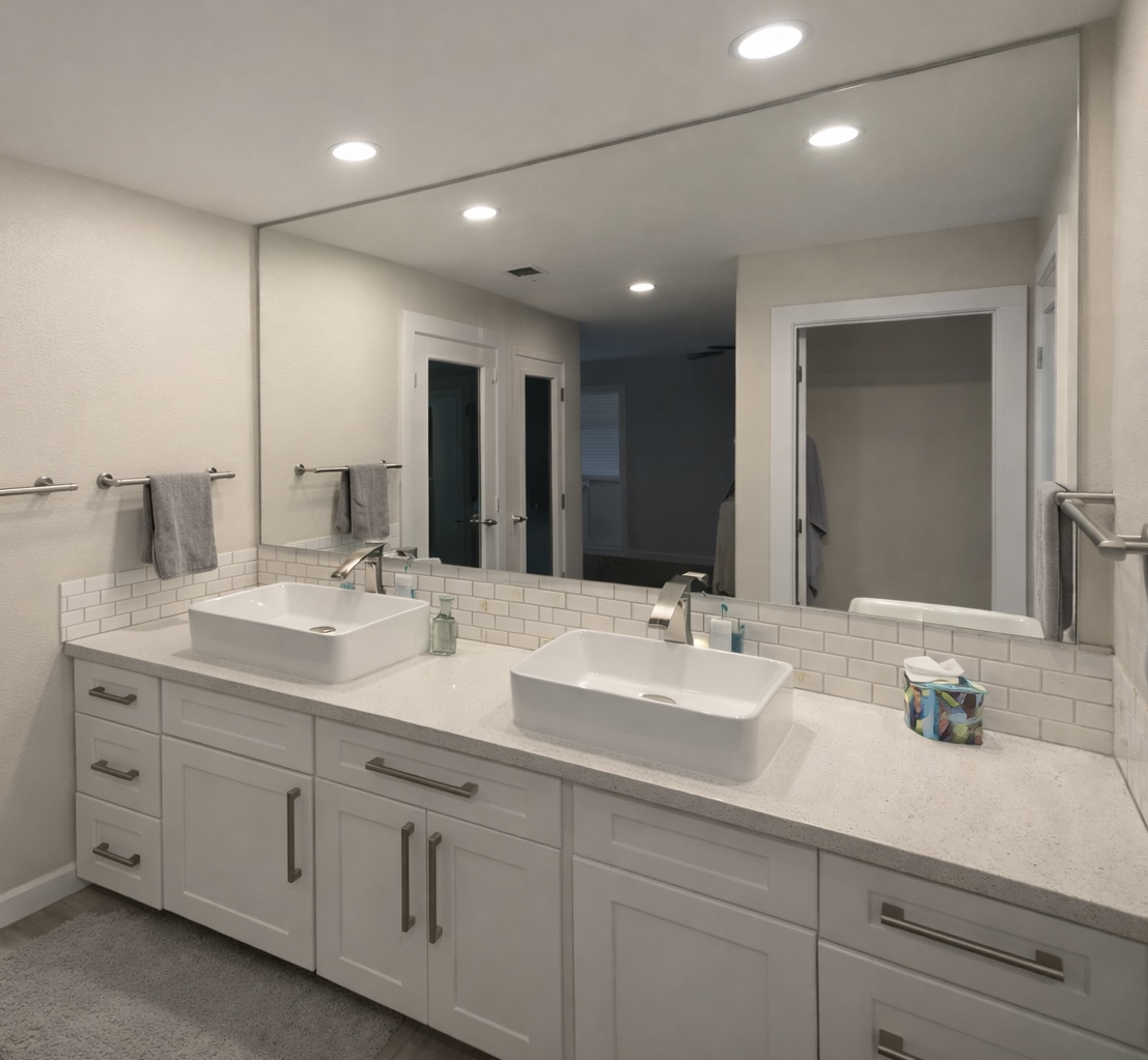 Modern bathroom vanity with two rectangular vessel sinks, white countertop, large mirror, and white cabinetry.