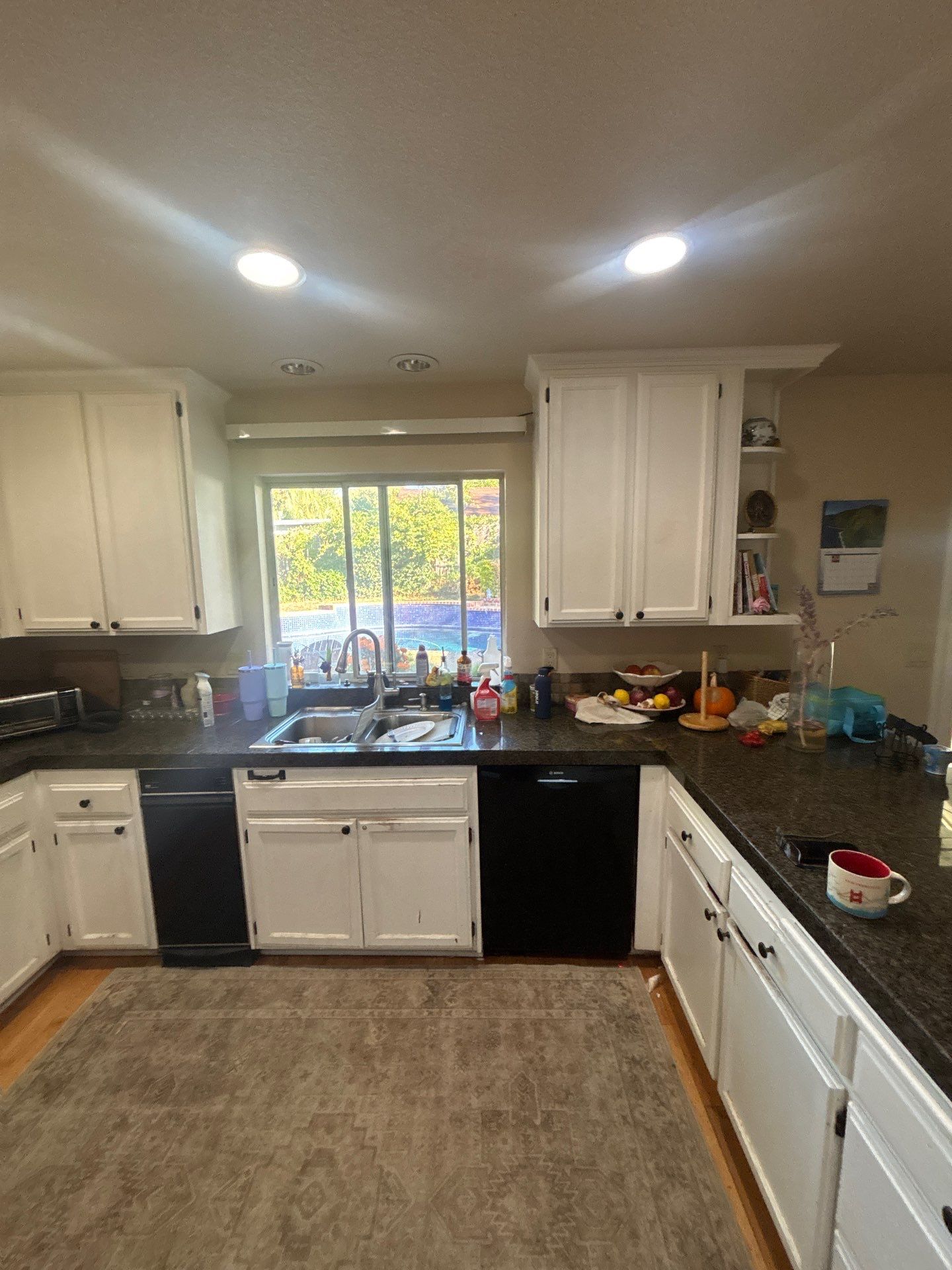 Modern bathroom vanity with two rectangular vessel sinks, white countertop, large mirror, and white cabinetry.
