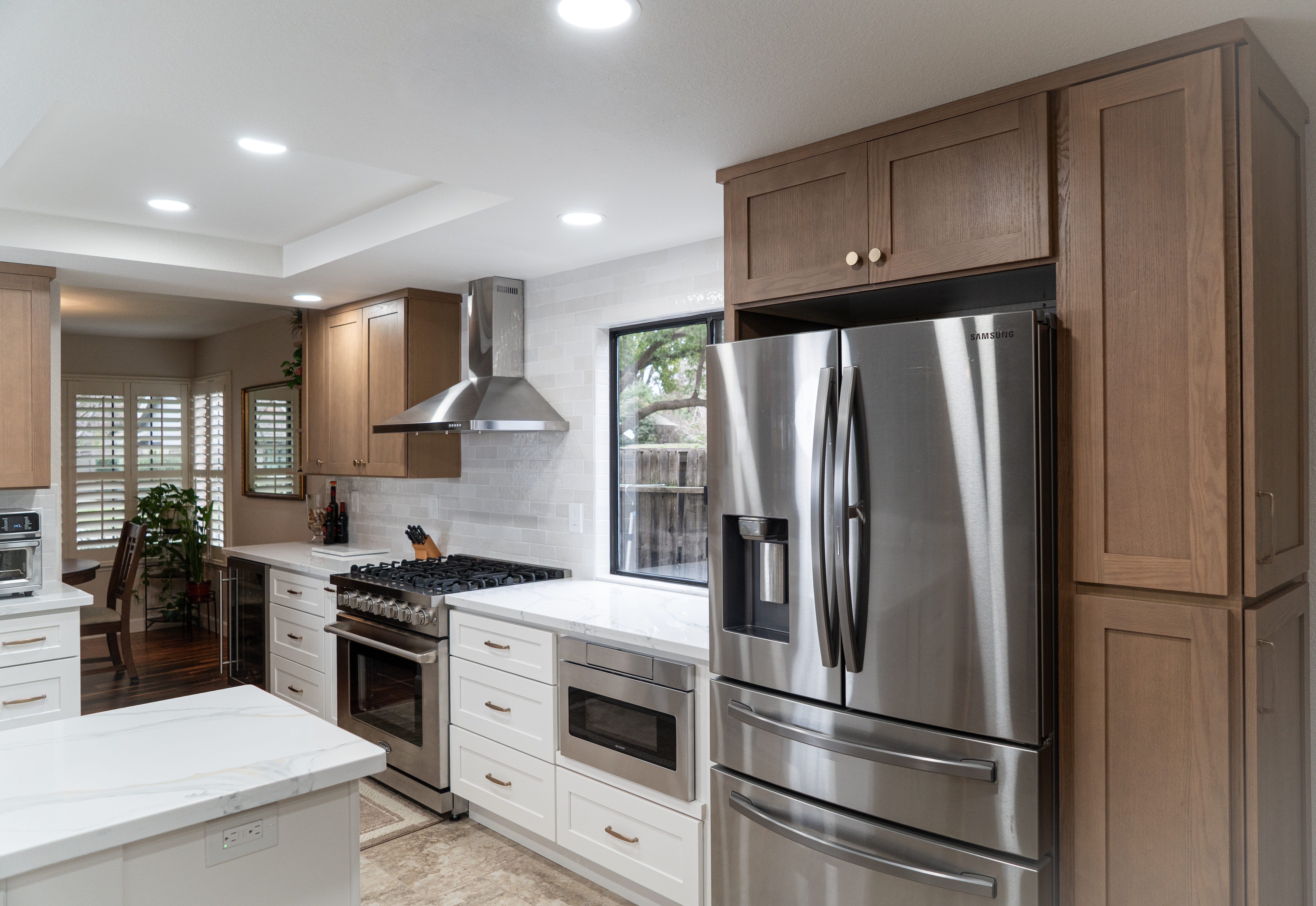 A grayscale shot focusing on a white kitchen island countertop and sink.