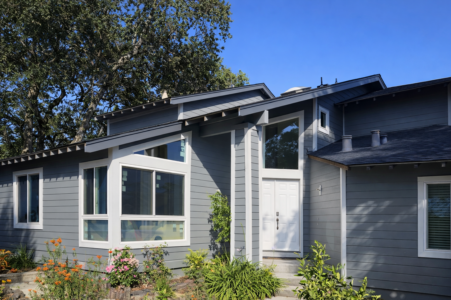 A grayscale photo of wooden kitchen shelves holding various bowls and carafes.