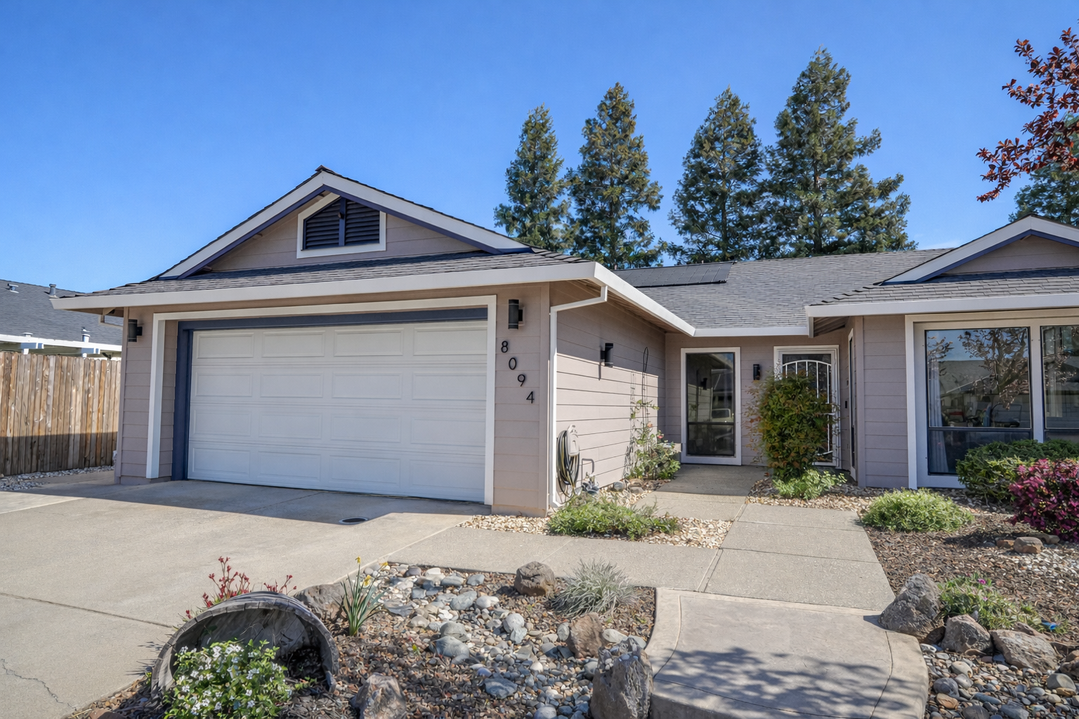 A grayscale photo of wooden kitchen shelves holding various bowls and carafes.