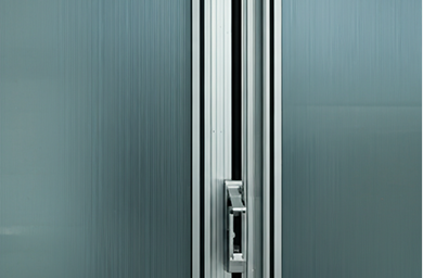 Close-up of a modern door handle on a textured blue-gray door.