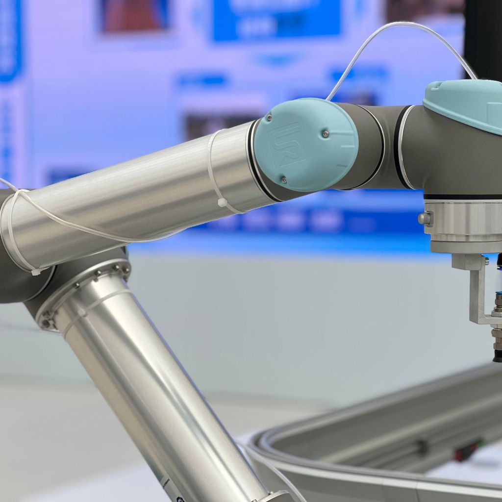Robot performing precision assembly in a manufacturing facility, representing cobot rental for skilled manufacturing work
