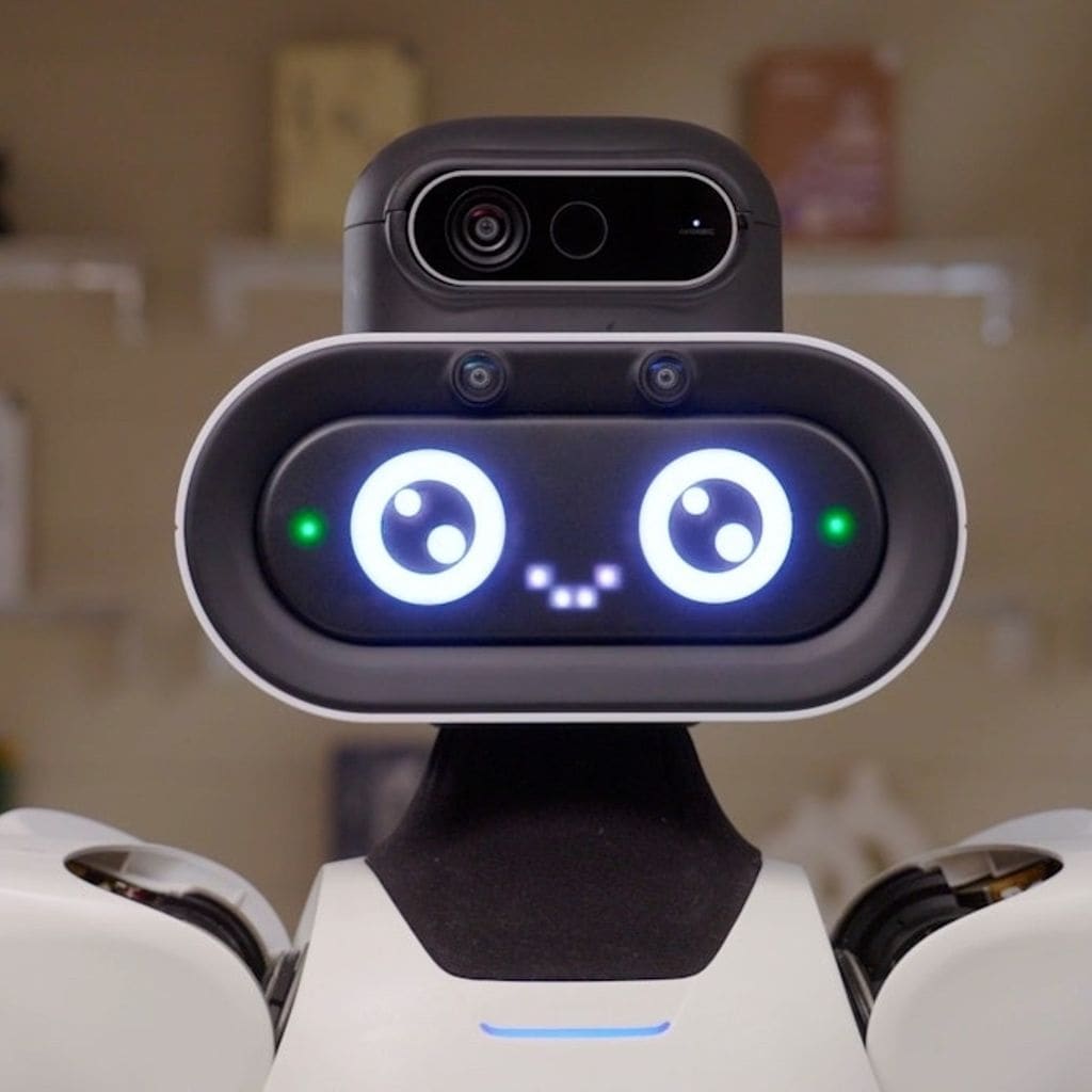 Asset investor reviews humanoid robot rental performance data on a warehouse floor with a humanoid robot stocking shelves in the background