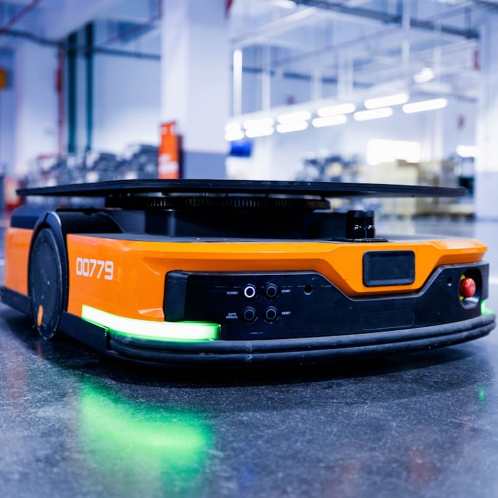 Warehouse professional observing a humanoid robot during a warehouse robot rental deployment on a modern logistics floor