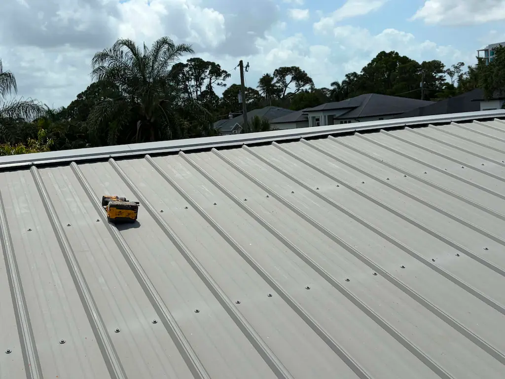 Replaced fasteners across an exposed-fastener metal office roof in Bonita Springs
