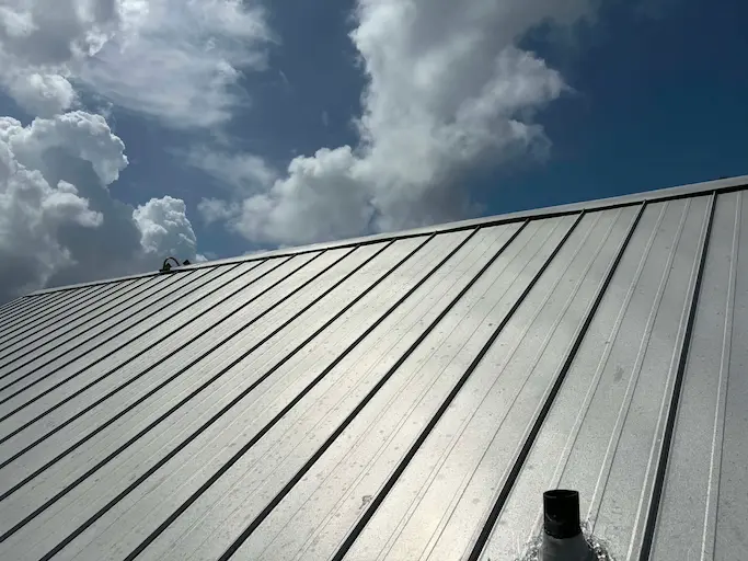 Re-set and re-sealed standing seam ridge cap on a Bonita Springs metal roof