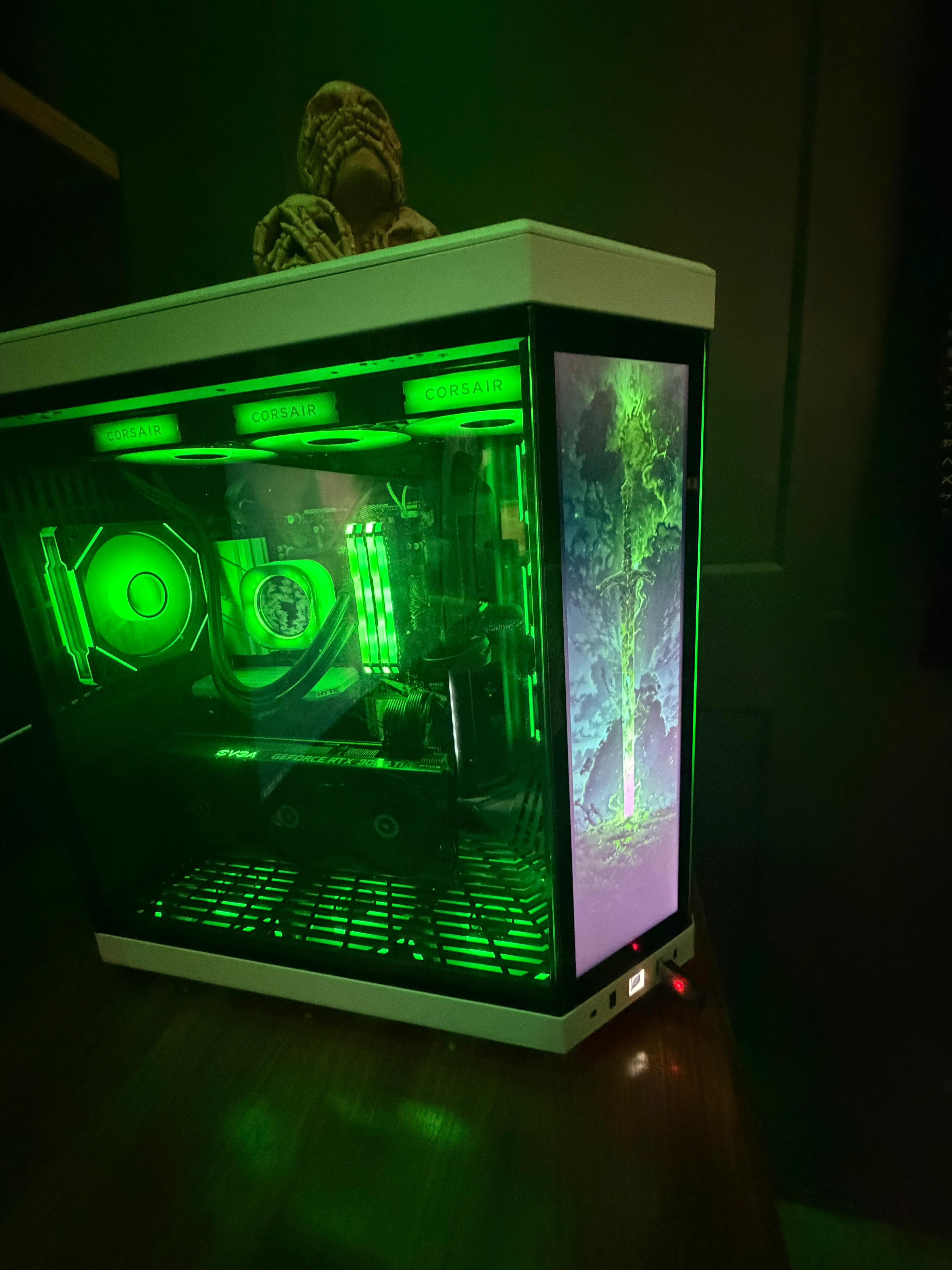 Gaming PC tower with transparent side panel showing illuminated internal components and RGB lighting.