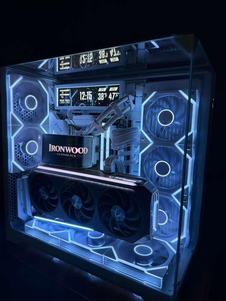 Gaming PC tower with transparent side panel showing illuminated internal components and RGB lighting.