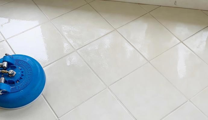 Freshly cleaned white tile floor with bright, restored grout lines