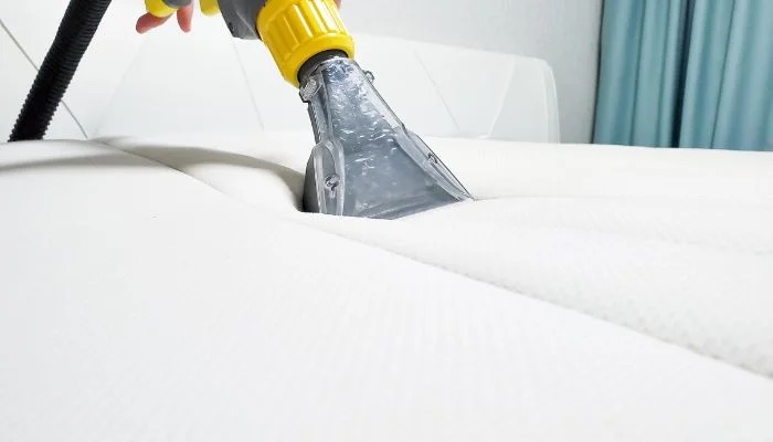 Mattress being sanitized with a professional extraction tool