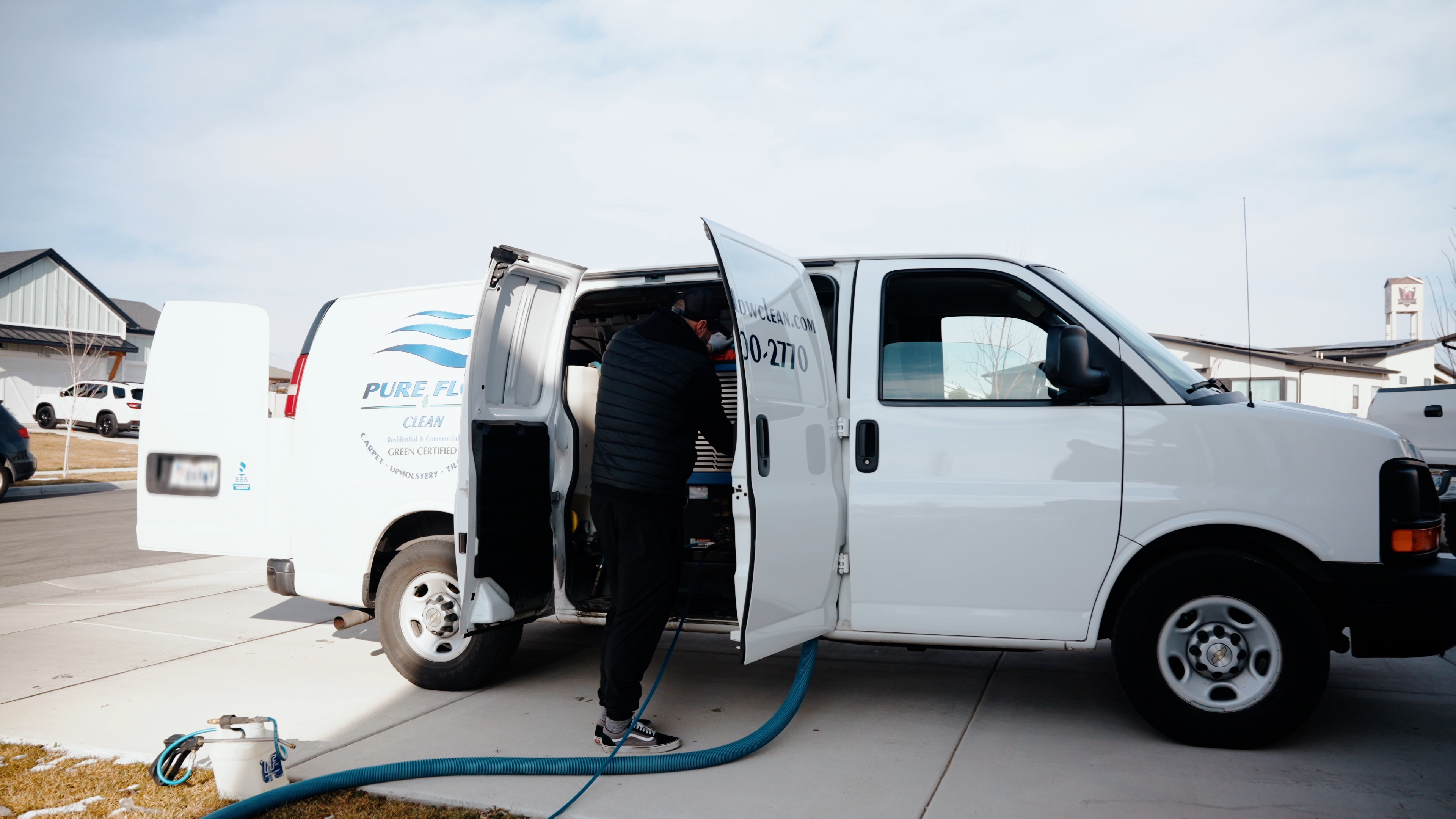 Pure Flow Clean technician unloading equipment from the service van for auto interior detailing
