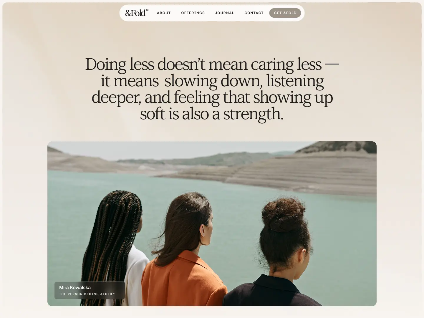 Three women viewed from behind looking out over a calm lake with hills in the background, above a quote about strength in softness.