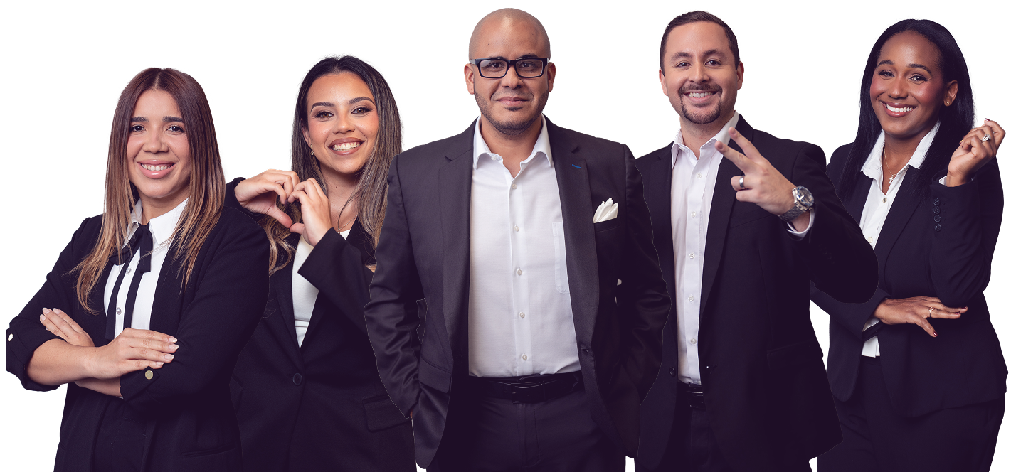 Five professional individuals in business attire smiling, with one making a heart shape with her hands and another showing a peace sign.