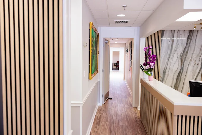 Clean and welcoming hallway inside Sharon Orthodontics office leading to treatment rooms