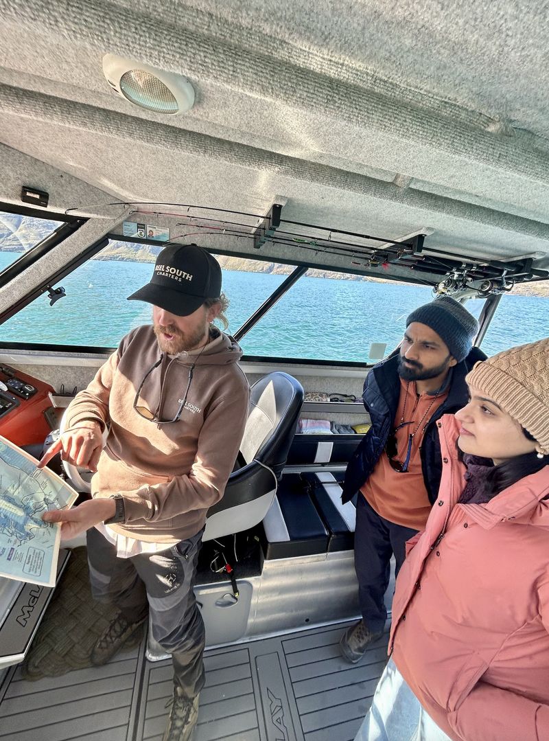 Reel South Charters guide showing guests the map
