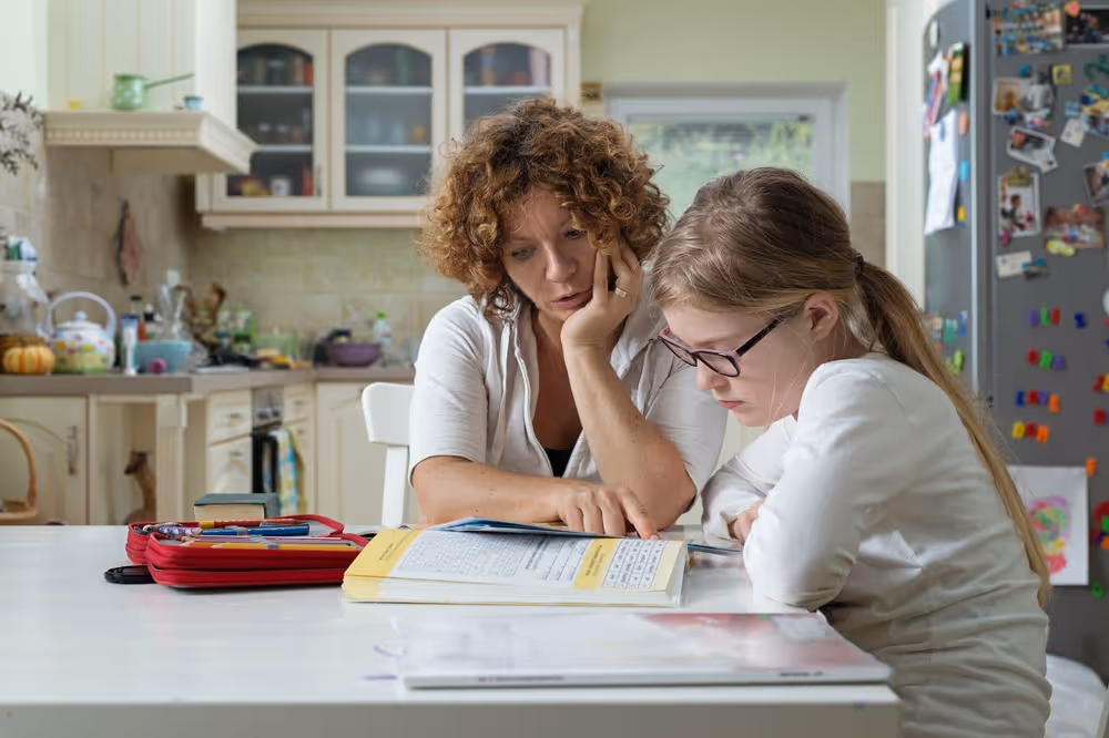 Parent guiding kid on study.