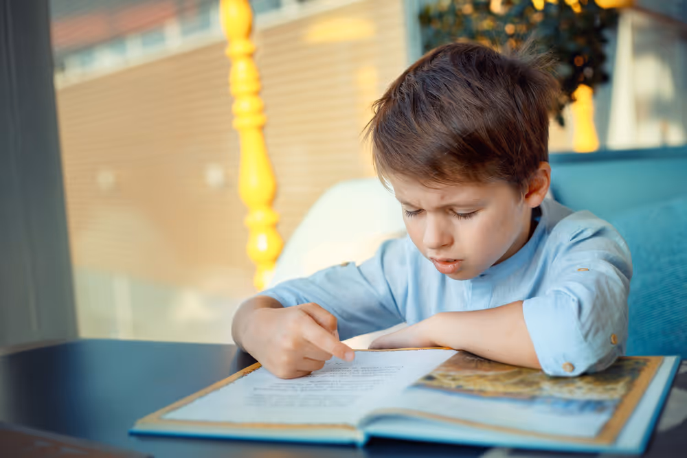 Kid reading a book.
