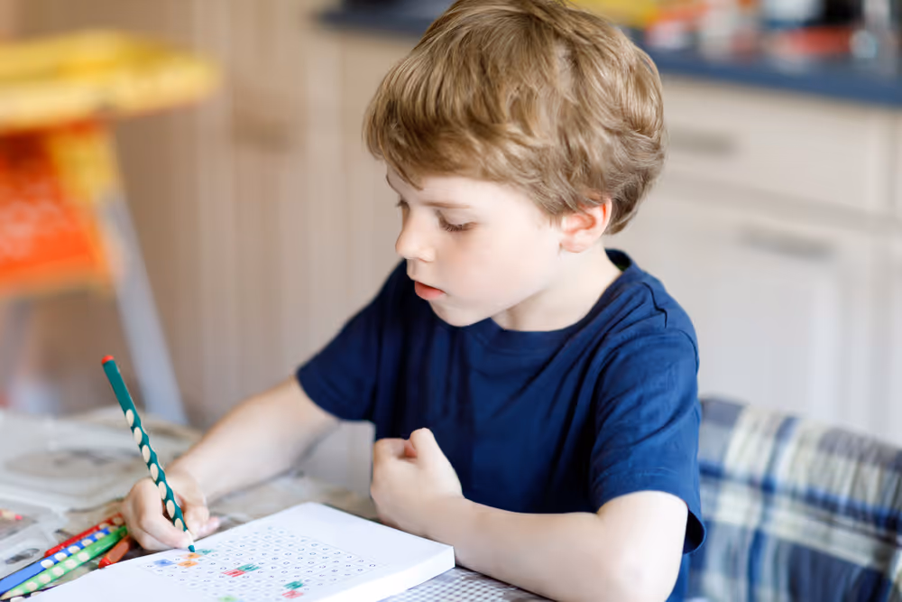 Kid is writing with pencil