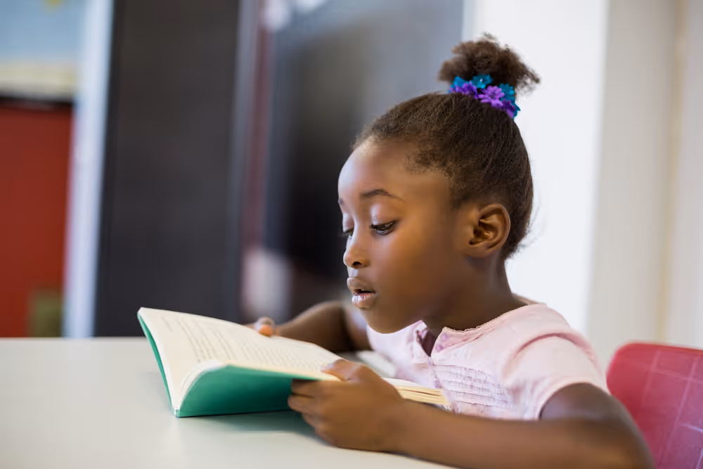 Kid reading a book.