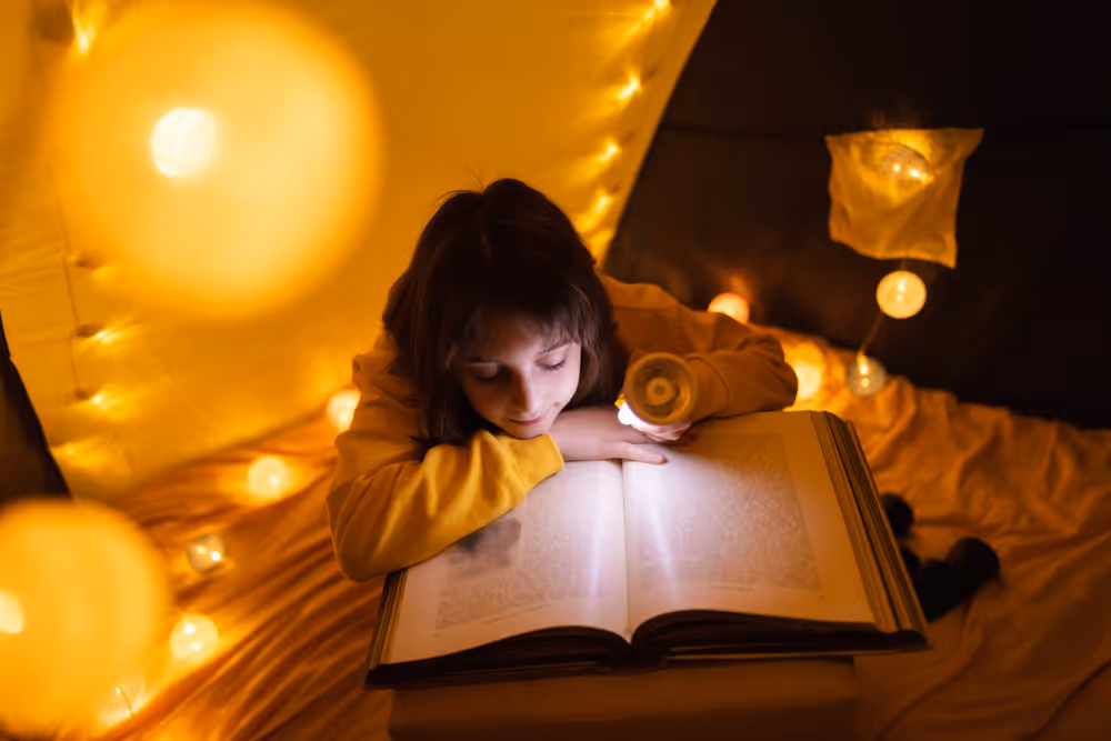 Kid reading book in a well lit room
