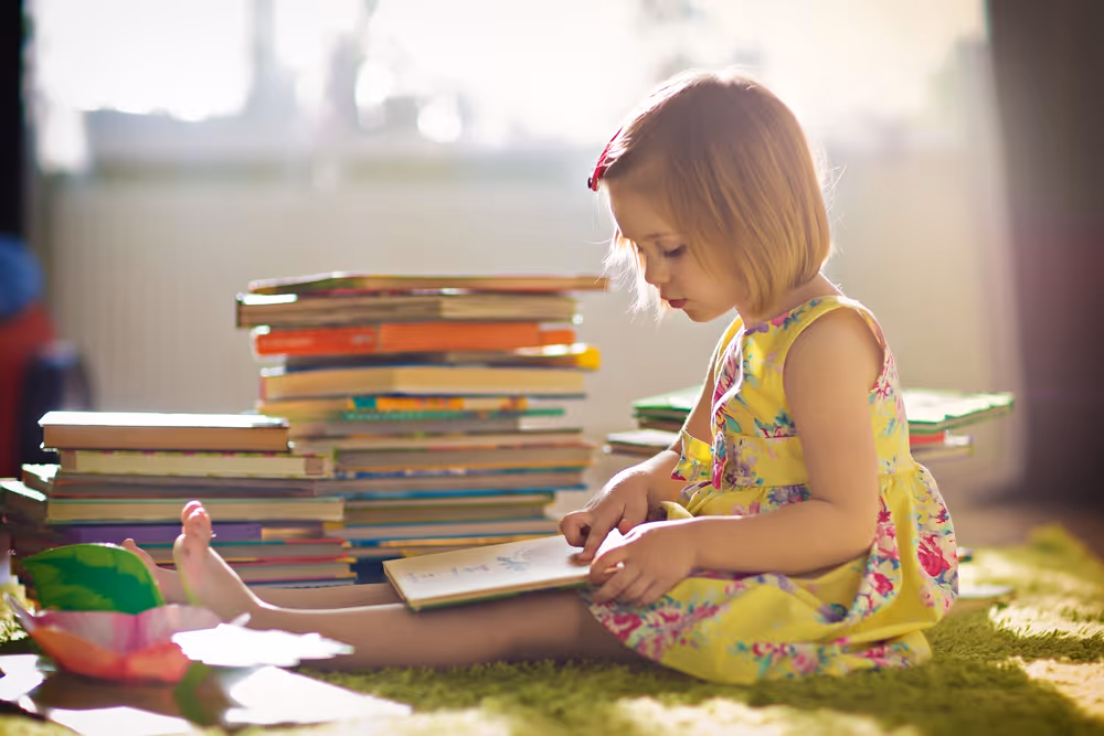 Kid reading a colorful book