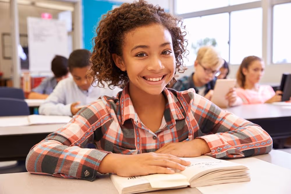 kid reading happily in classroom