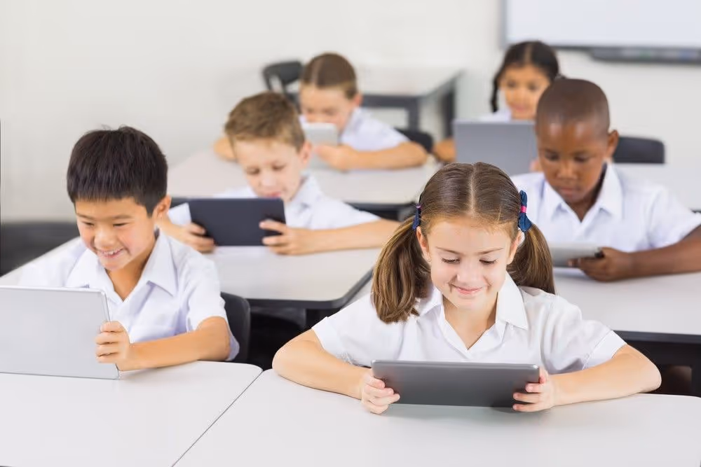 cildren reading happily in classroom using readability reading app