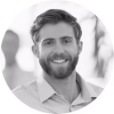 a man with a beard smiling