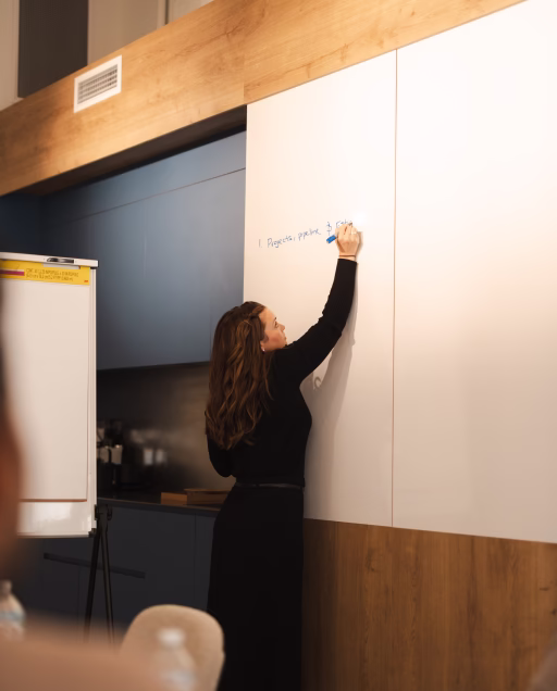 woman writing on a white board