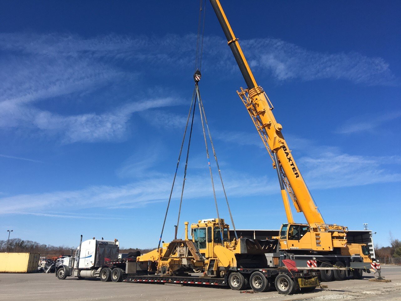 Baxter Crane lifting tracked excavator onto flatbed trailer