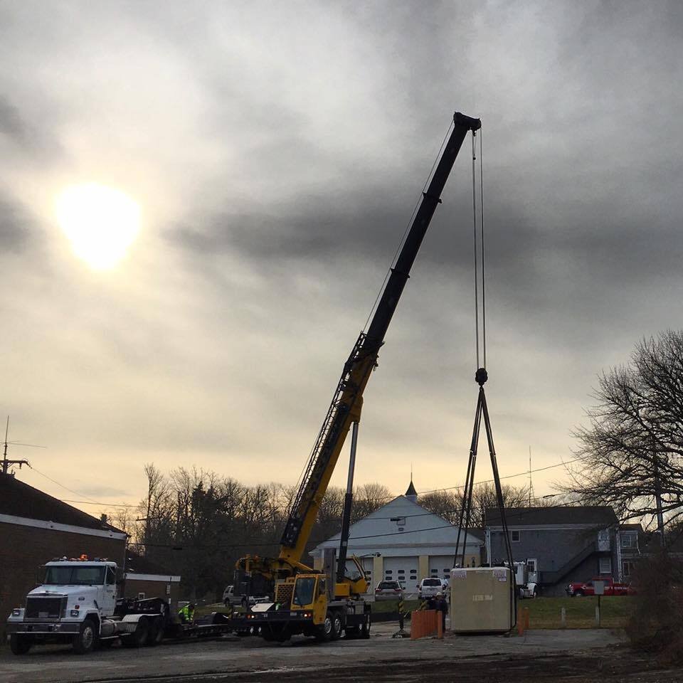 Baxter Crane lifting generator at sunset
