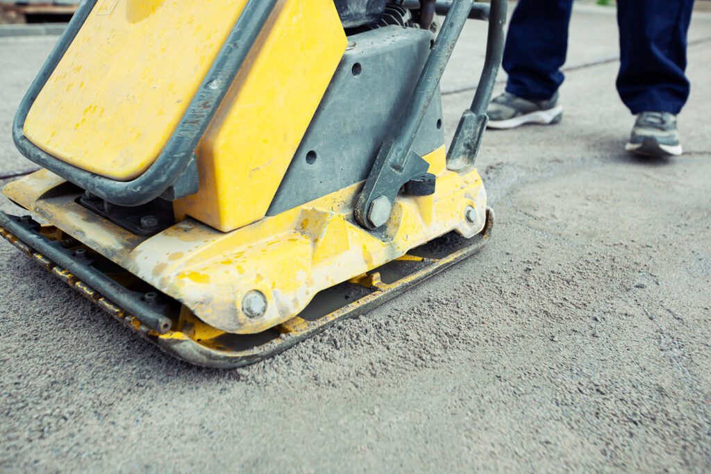 plate compactor on gravel