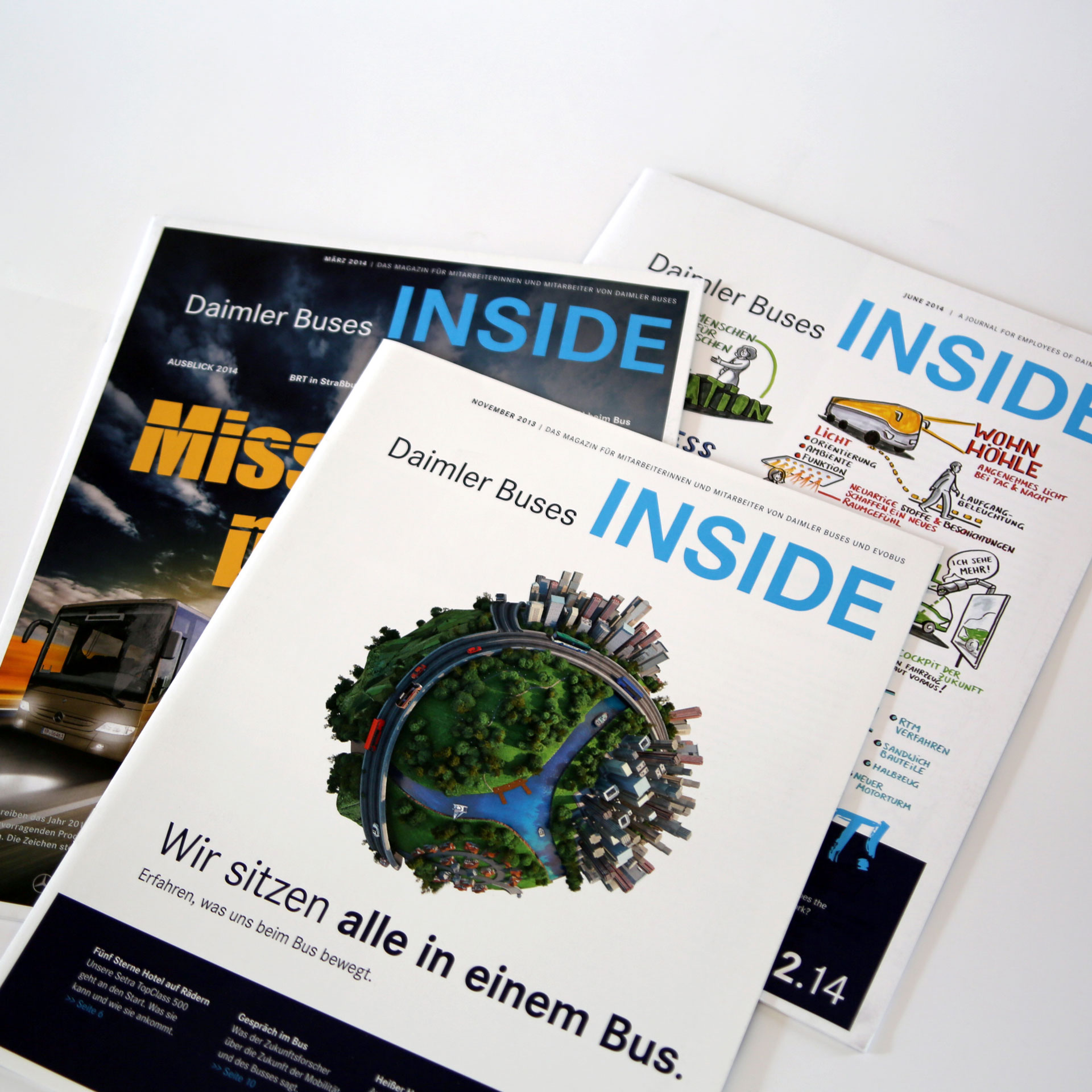 Drei Daimler Buses INSIDE Magazine-Ausgaben mit verschiedenen Titelbildern und Schwerpunkten nebeneinander liegend.