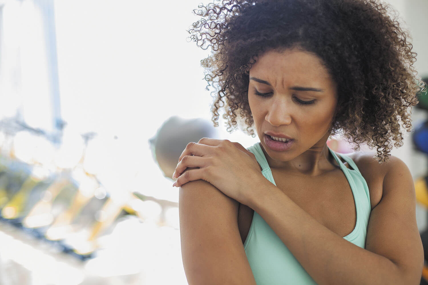 Woman grabbing shoulder in pain
