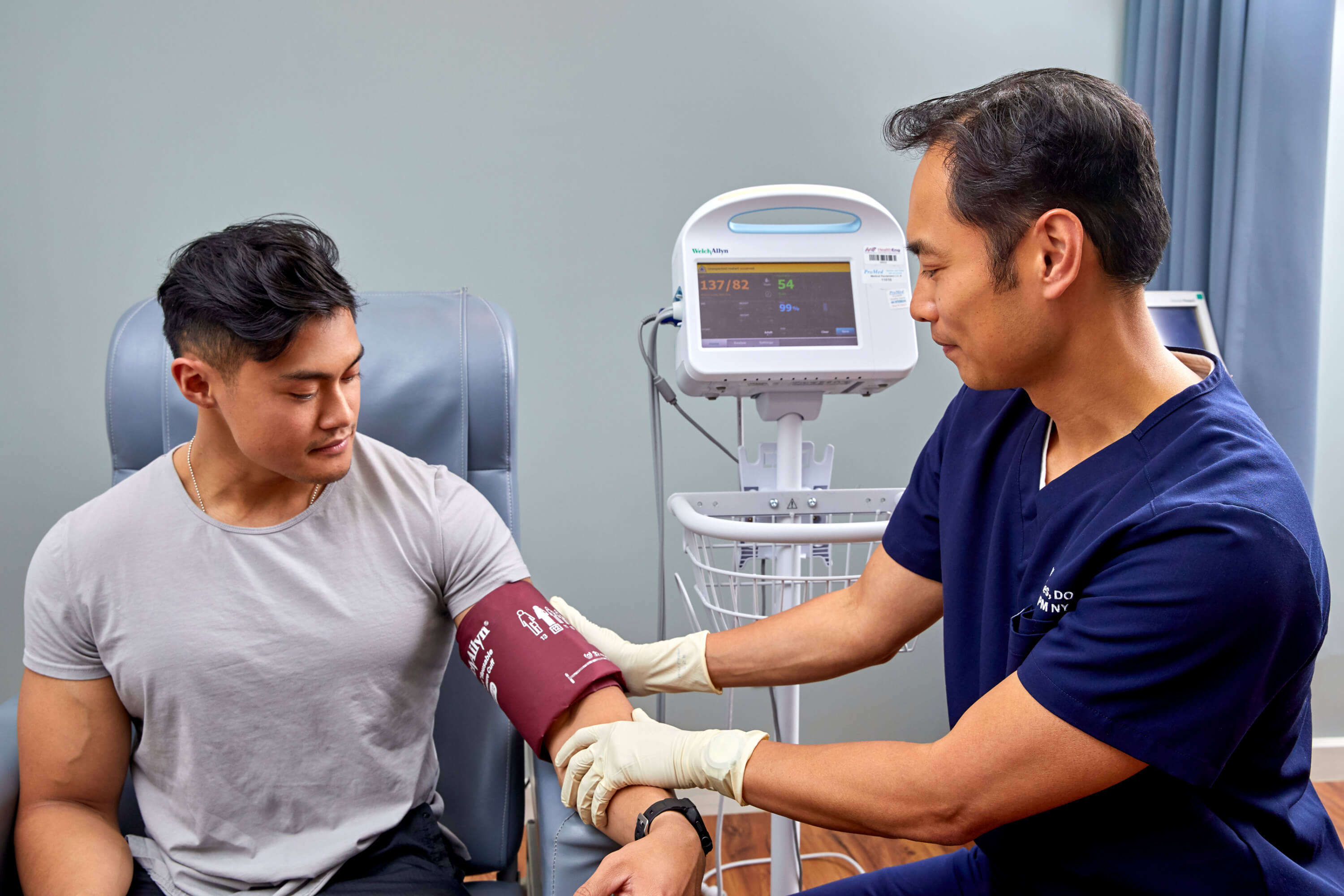 Dr. Rances using blood pressure machine on patient
