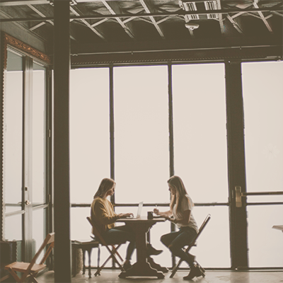 A smart woman working on finding promotional products her laptop at a desk with a coffee