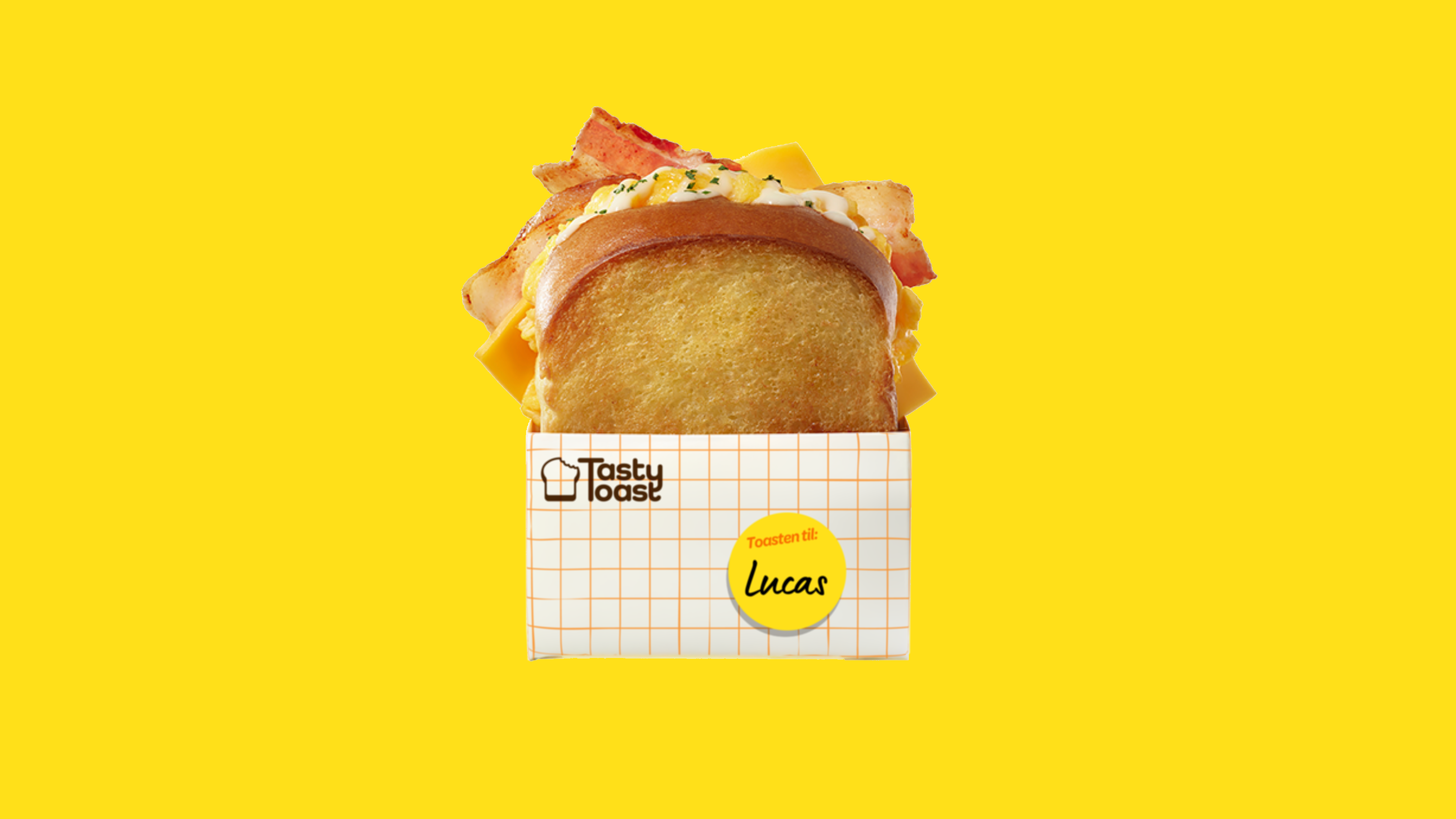 Toasted sandwich with bacon, scrambled eggs, and cheese in a branded wrapper on yellow background.