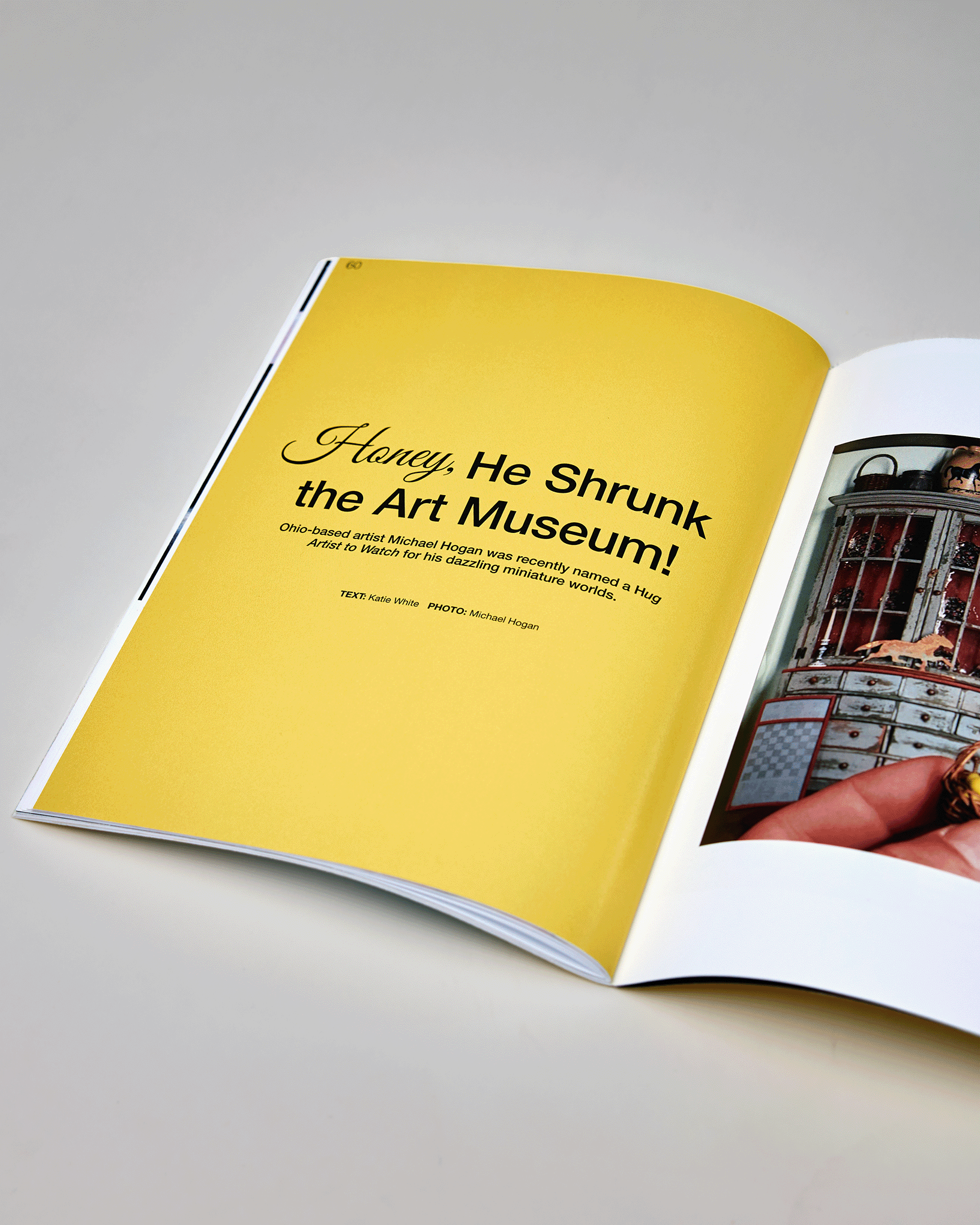 Open magazine with yellow page titled 'Honey, He Shrunk the Art Museum!' about artist Michael Hogan.