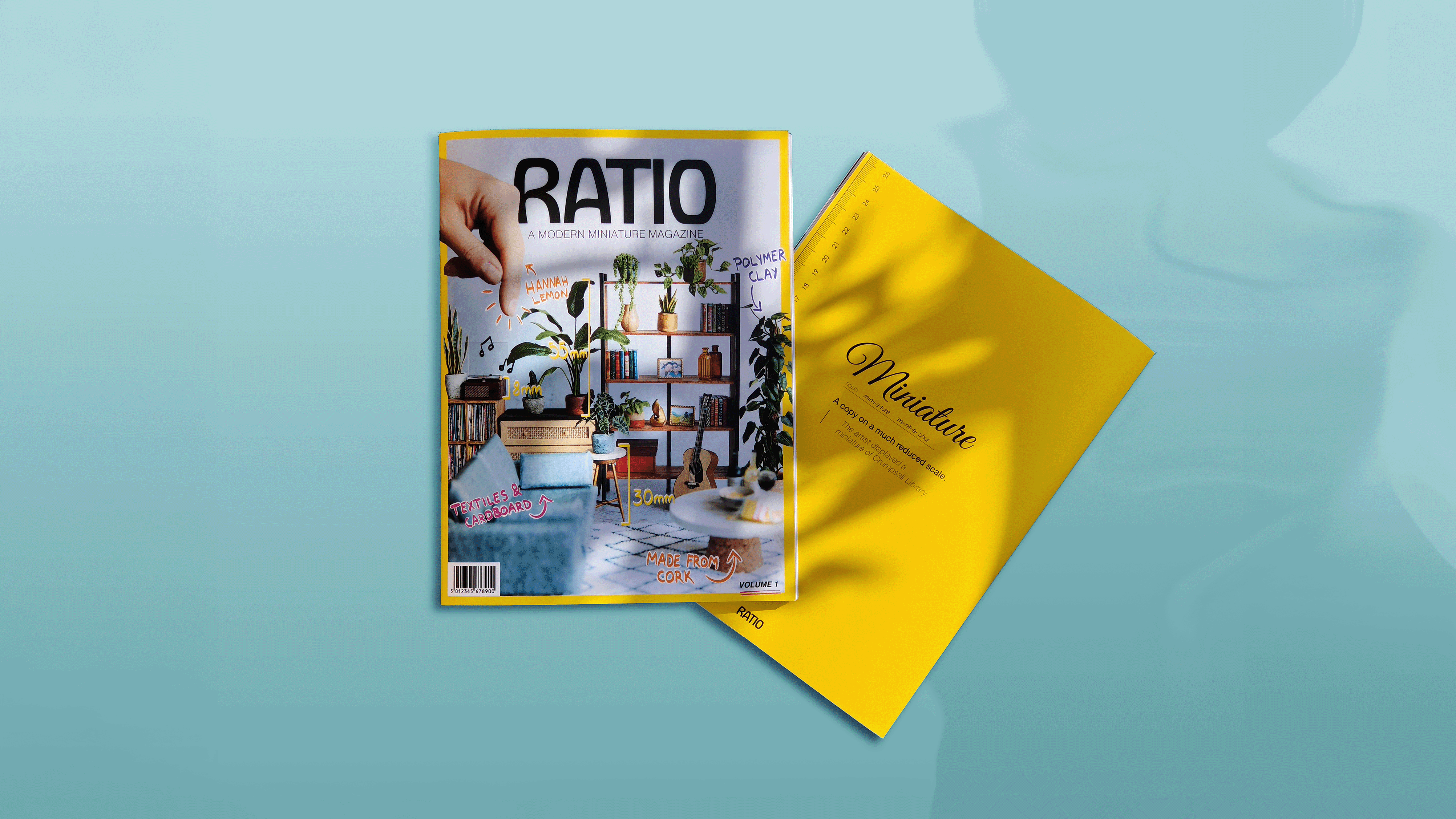 Two magazines on turquoise surface, one open with furniture miniatures and measurements on cover.