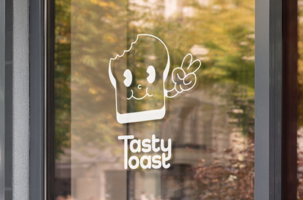 Logo of a smiling slice of toast making a peace sign above the text 'Tasty Toast' on a glass door.