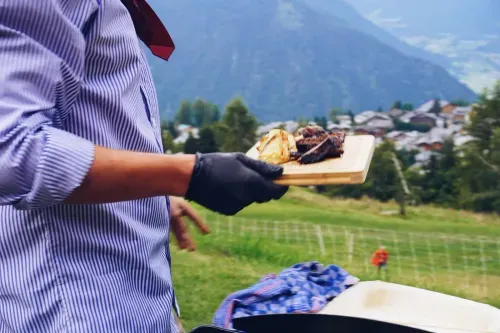 Chef serving with the Verbier Alps behind