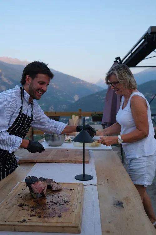 Chef and guest laughing over the board