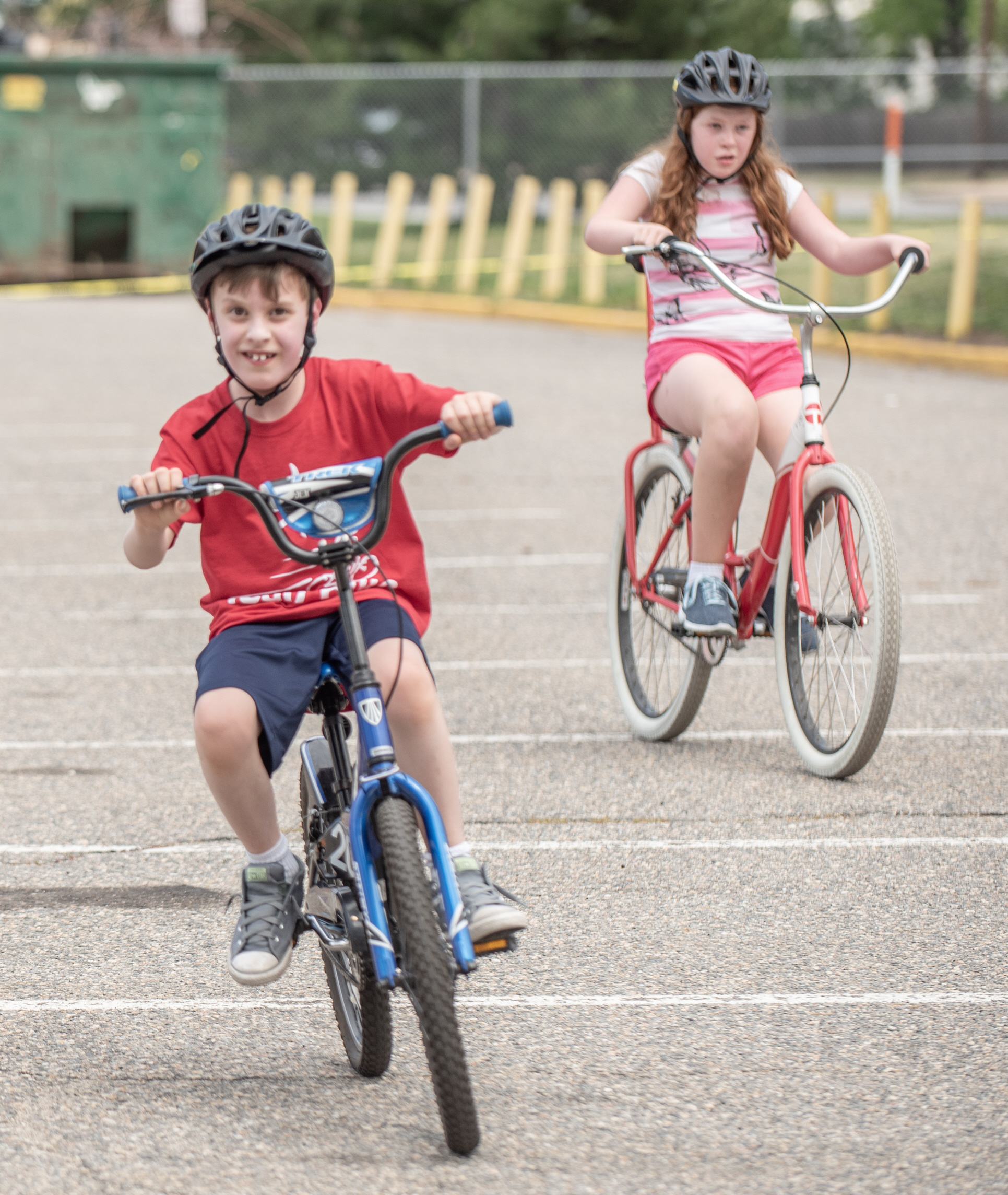 Two children with disabilities riding bikes together at Cycle Movement's adaptive cycling camp, wearing helmets and building independence in Colorado