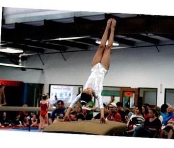 Ashlen competing in gymnastics as a young athlete