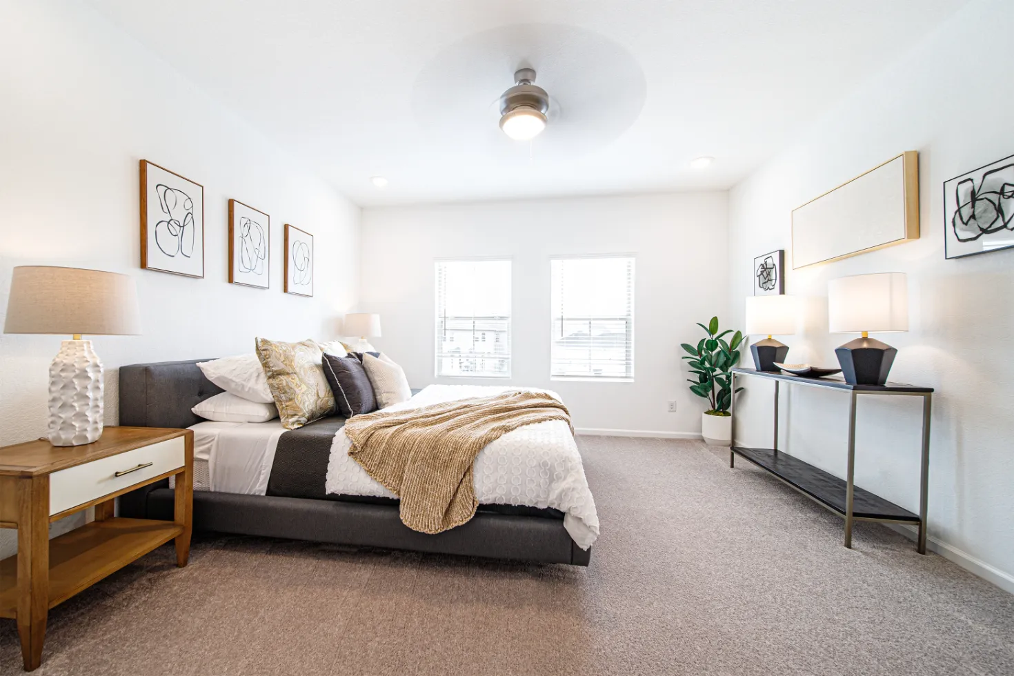 bedroom with bed, bedside table, and two large windows