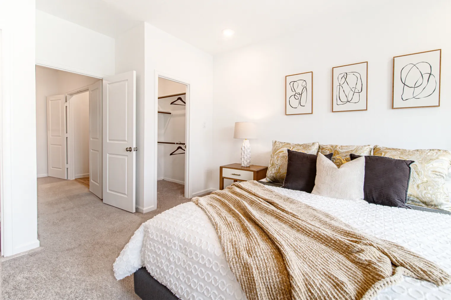 bedroom with bed and view of walk in closet and hallway
