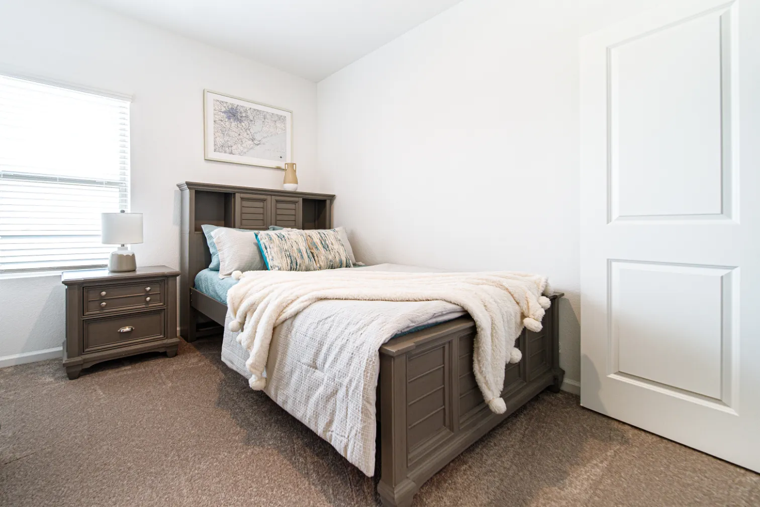 Bedroom with bed and bedside table by window