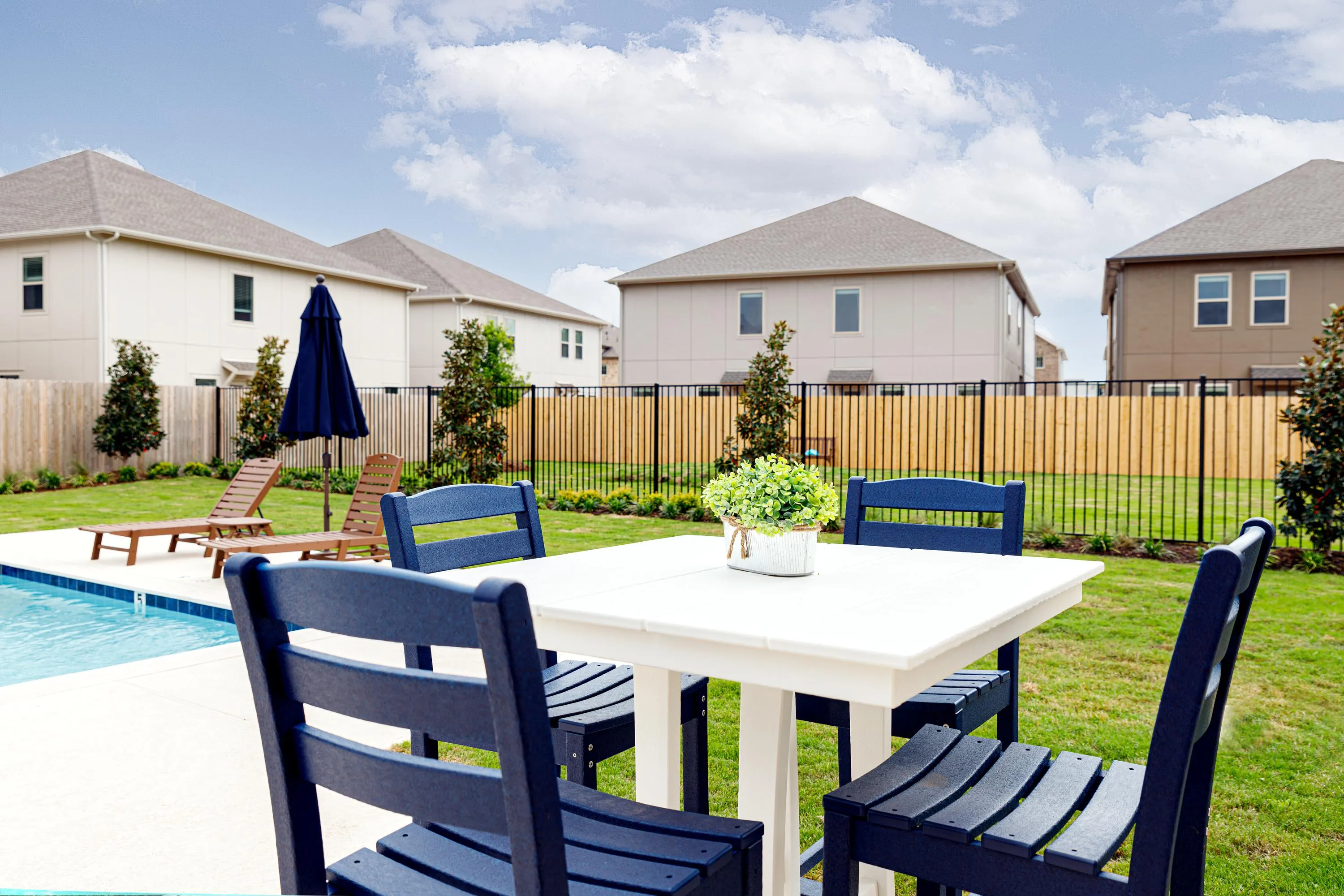 swimming pool with lounge chairs and umbrellas